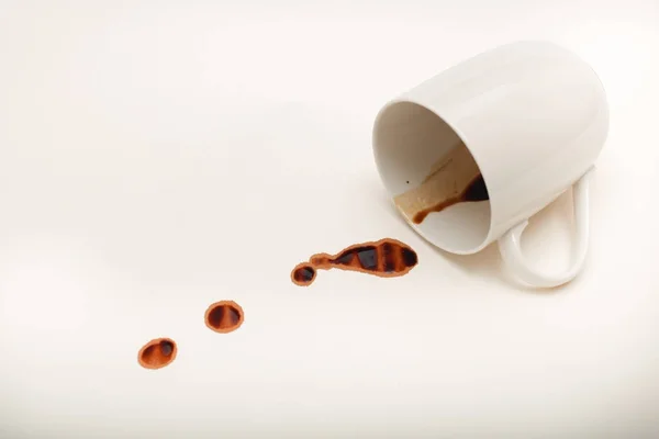 Vista de perto da caneca de café vazia com gotas de café molhadas no branco — Fotografia de Stock