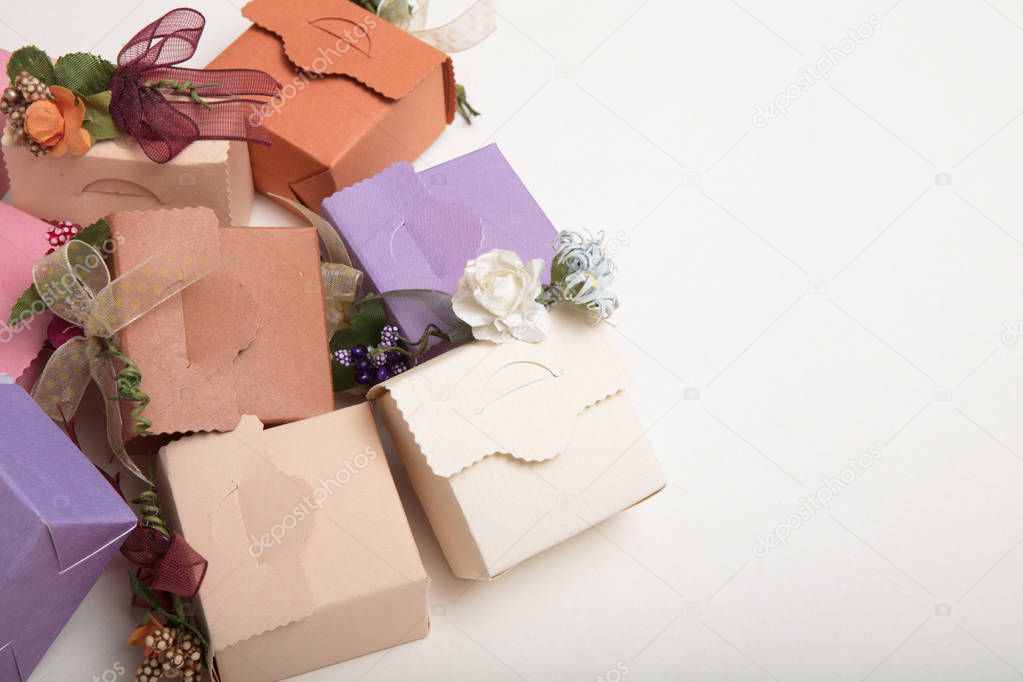 Light colours gift boxes  with flowes and ribbons, on white back