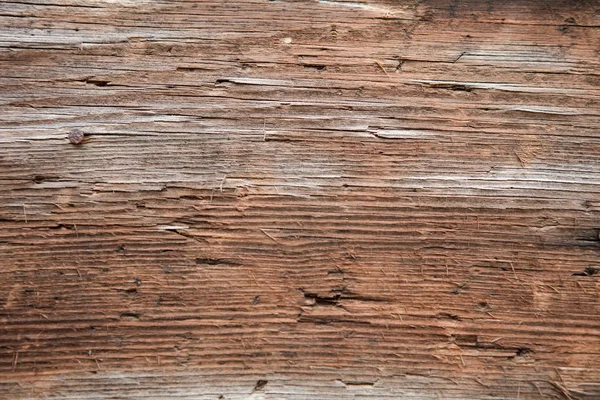 Primer plano de una pared exterior de madera muy erosionada — Foto de Stock