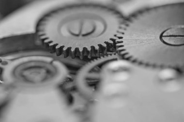 Çarklar. Siyah ve beyaz dişliler, saat mekanizması. Zaman kavramı, takım çalışması, başarı.