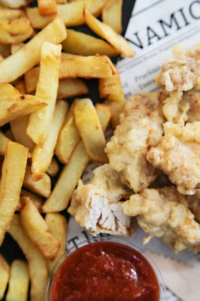 french fries with chicken rissole on the black background.junk food