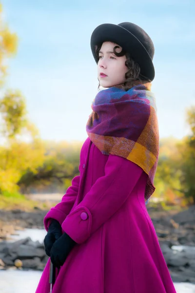 Chica con un abrigo carmesí brillante y un paraguas caminando por la rive —  Fotos de Stock