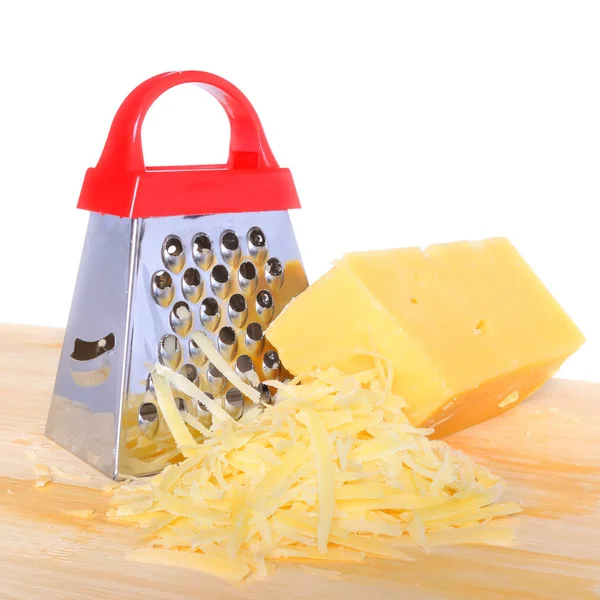 Bar cheese grater and grated cheese on cutting board isolated — Stock Photo, Image