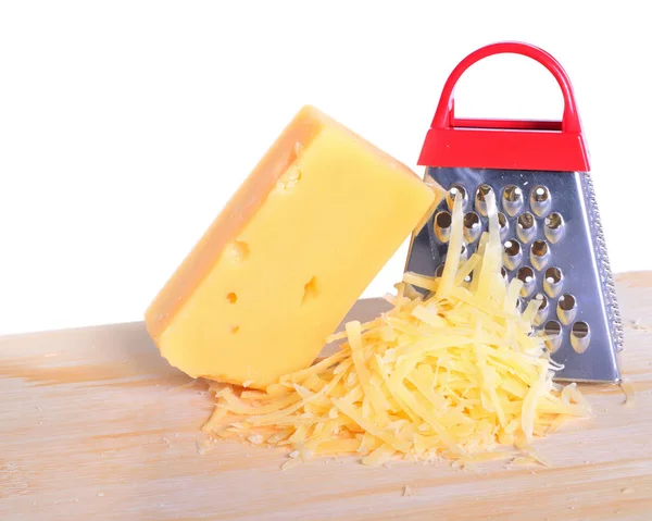 Bar cheese grater and grated cheese on cutting board isolated — Stock Photo, Image