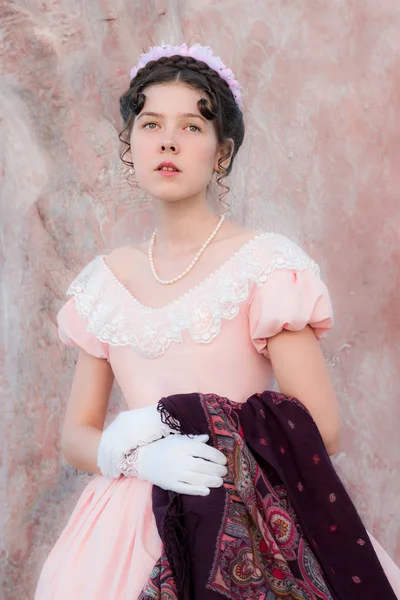 Romantisches Mädchen im Abendkleid steht in der Nähe einer Wand aus rosa — Stockfoto