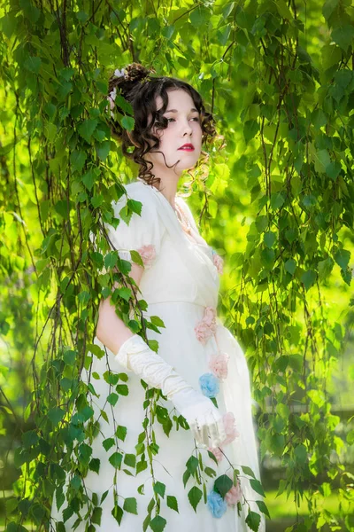 Nő, egy hosszú, elegáns fehér menyasszonyi ruha, egy parkban. — Stock Fotó