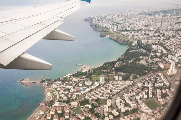 A beautiful view from the window of an airplane flying over the city. Antalya, Turkey