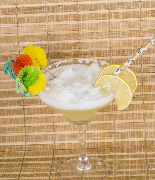 a glass of cocktail with lemon on background.