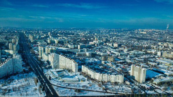 Top view of city in winter at sunset on sky background. Aerial drone photography concept. Kishinev, Republic of Moldova.