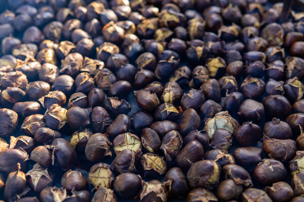 chestnuts roasted on the fire from a street vendor on the road in winter