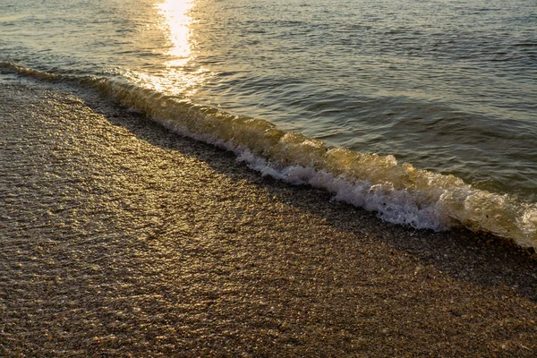Soft wave of the sea on the sandy beach on sunrise — Stock Photo, Image