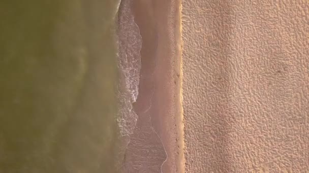 Plage et vue aérienne sur la mer. rivage vagues douces et cailloux dans la mer. La couleur de l'eau magnifiquement lumineux le matin. Vidéo 4K 