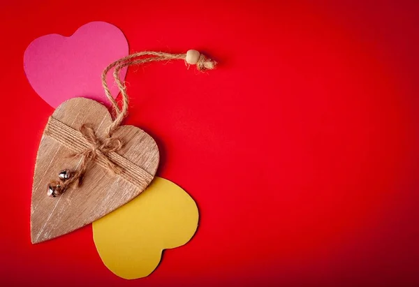Decorative wooden heart on a red background. Holidays. Valentine's Day. Text spase.