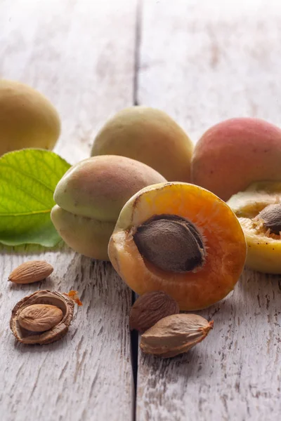 Apricot fruit. Fresh organic apricots on a white wooden background. Vega food.