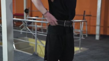 Man in Gym lifts the barbell, muscle training with weights, powerlifting.