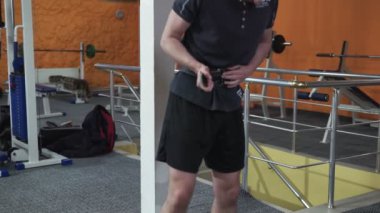 Man in Gym lifts the barbell, muscle training with weights, powerlifting.