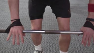 Man in Gym lifts the barbell, muscle training with weights, powerlifting.