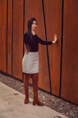 Modern binanın arka planında poz veren güzel bir kız modeli.