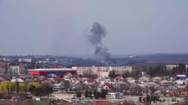 Şehirdeki bir yangından çıkan siyah duman. Şehirde büyük bir yangın, kalın siyah bir duman sütunu şehrin ve yerleşim yerlerinin üzerine yükseliyor. Binadaki yangın kavramı, yangını söndürmek..