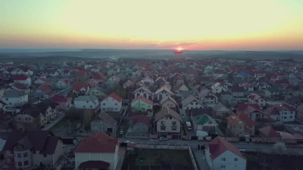 Légi járat egy külváros felett naplementekor — Stock videók
