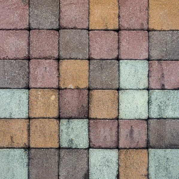 Brick pavement tile, top view. Urban texture as background. Stone pavement texture. Granite cobblestoned pavement background.
