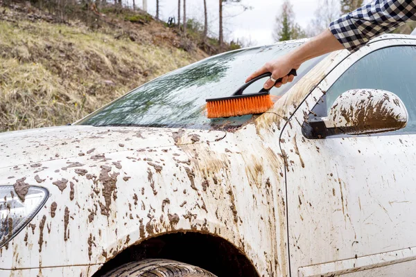 Man washing dirty car