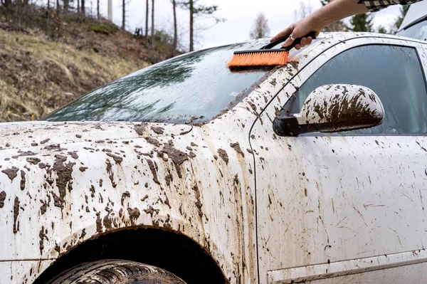 Man washing dirty car