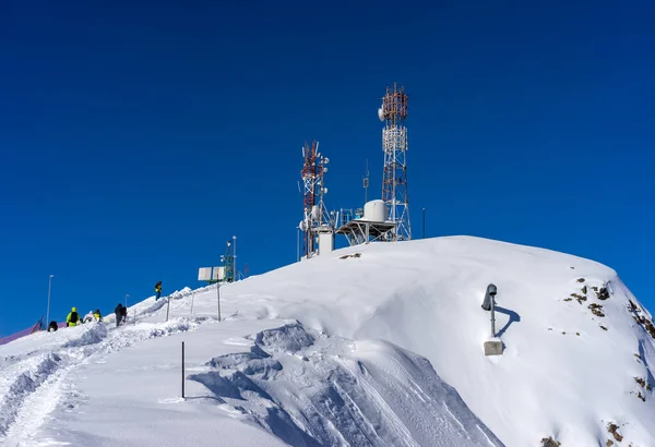 Tower with telecommunications equipment, mobile communications and meteorological autonomous mini station for study and determination of weather in winter period on top of mountain on winter resort