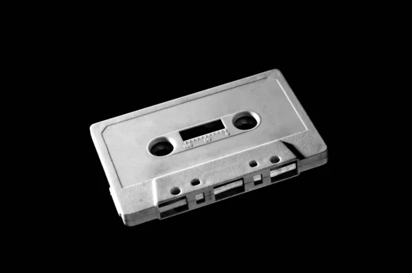 old white audio cassette on dark background