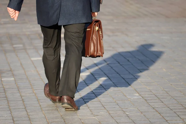 Man Business Suit Carrying Leather Briefcase Walking Street Shadow Pavement — Stock Photo, Image