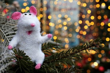 Karda beyaz örülmüş oyuncak farenin olduğu yeni yıl kartı köknar dalları ve altın ışıklarla kaplıydı. Çin Fare Yılı, Zodiac sembolü 2020