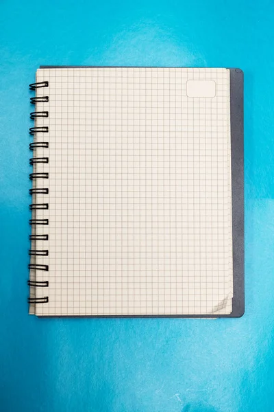 Blank sheet of notebook on blue background — Stock Photo, Image