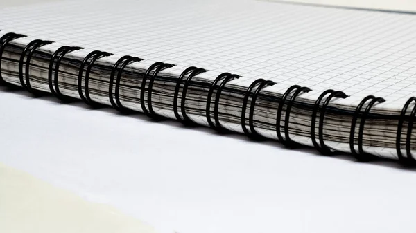 Black binding of thick notebook on white table — Stock Photo, Image