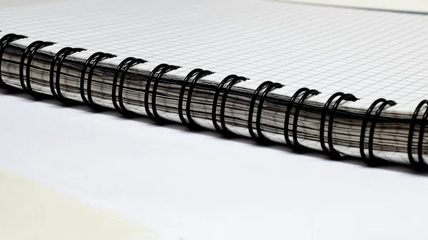 Black binding of thick notebook on white table Stock Picture