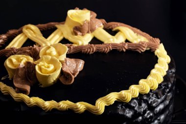 Chocolate cake with yellow cream close up