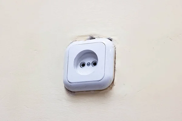 White electrical outlet on an old wall — ストック写真