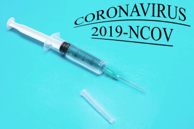 Syringe with medicine on a blue background