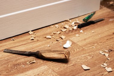 Chisel among sawdust on a wooden floor