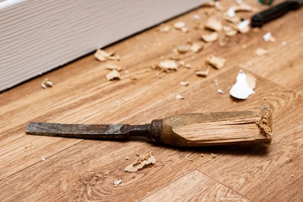 Chisel among sawdust on a wooden floor Stock Picture