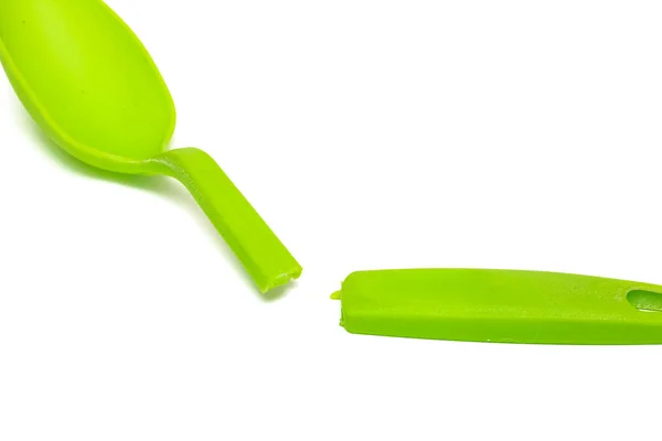 Broken green plastic spoon isolated on a white background — Stock Photo, Image