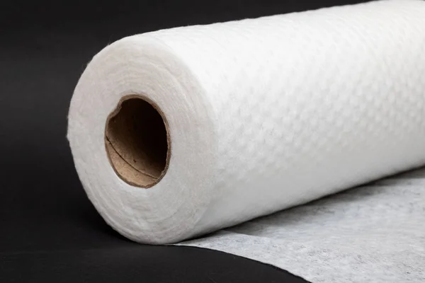 Roll of fabric napkins on a black background