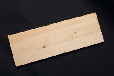 Wooden board on black background close up