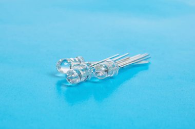 Three white LEDs diodes on a blue background