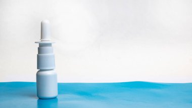 Drops for nose on a blue table