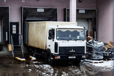 BELARUS, MINSK - MARCH 10, 2020: Unloading goods on a snowy day