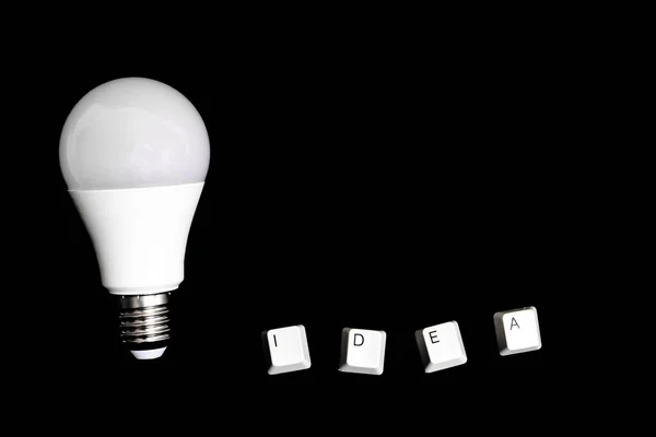 White Light Bulb Word Idea Black Background — Stock Photo, Image