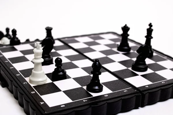 Captured king of chess on a white background close up