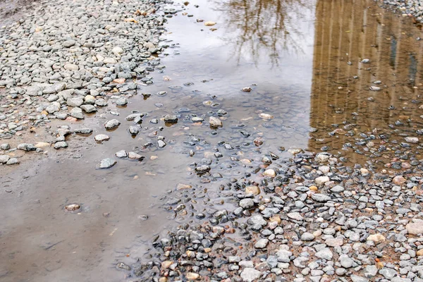 アスファルトの道路の近くのピット内の水たまり — ストック写真