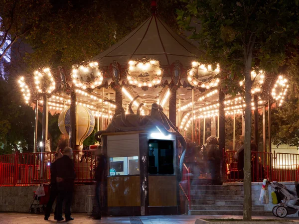 Fun fair and night. Beautiful bright carousel in park at night in winter — Stock Photo, Image
