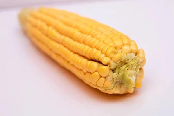 Oreja de maíz aislada en blanco. El maíz dulce está delicioso y listo para comer. Las verduras son beneficiosas para el cuerpo, tienen vitaminas y sabor delicioso. sobre fondo blanco —  Fotos de Stock